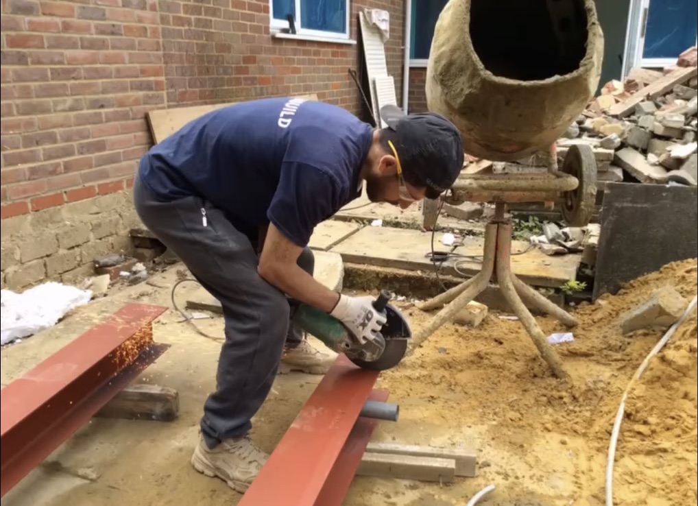 Lamabuild team working together on interior construction with exposed brick